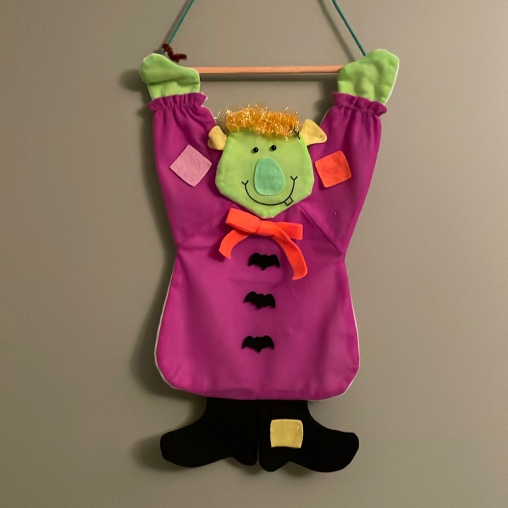 Vintage Halloween felt wall hanging monster. String on wood to hang. Used, 18” L